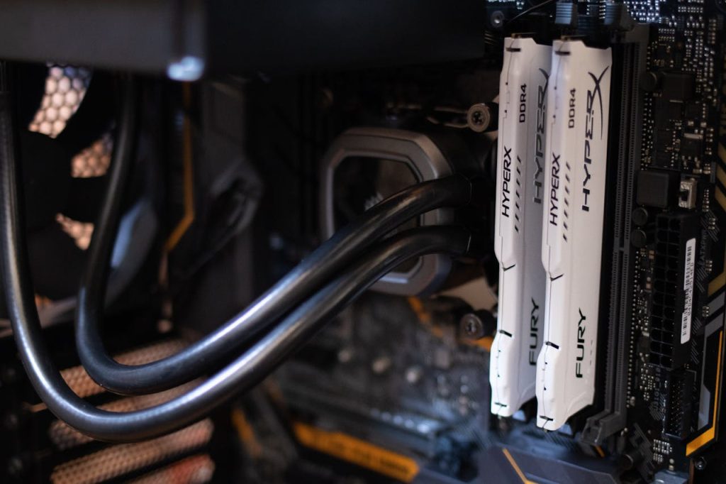pexels-photo-2582936 Detailed close-up of computer components including RAM and cables inside a server or high-performance PC.
