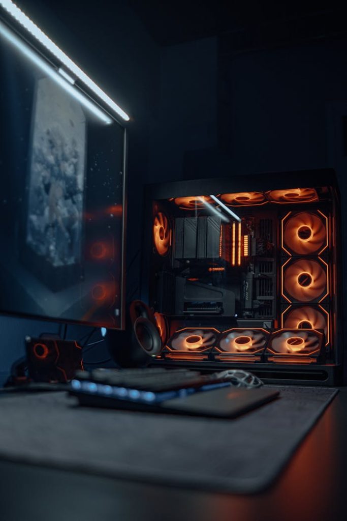 pexels-photo-30469971 A sleek gaming PC setup with vibrant RGB lighting and a high-resolution monitor.